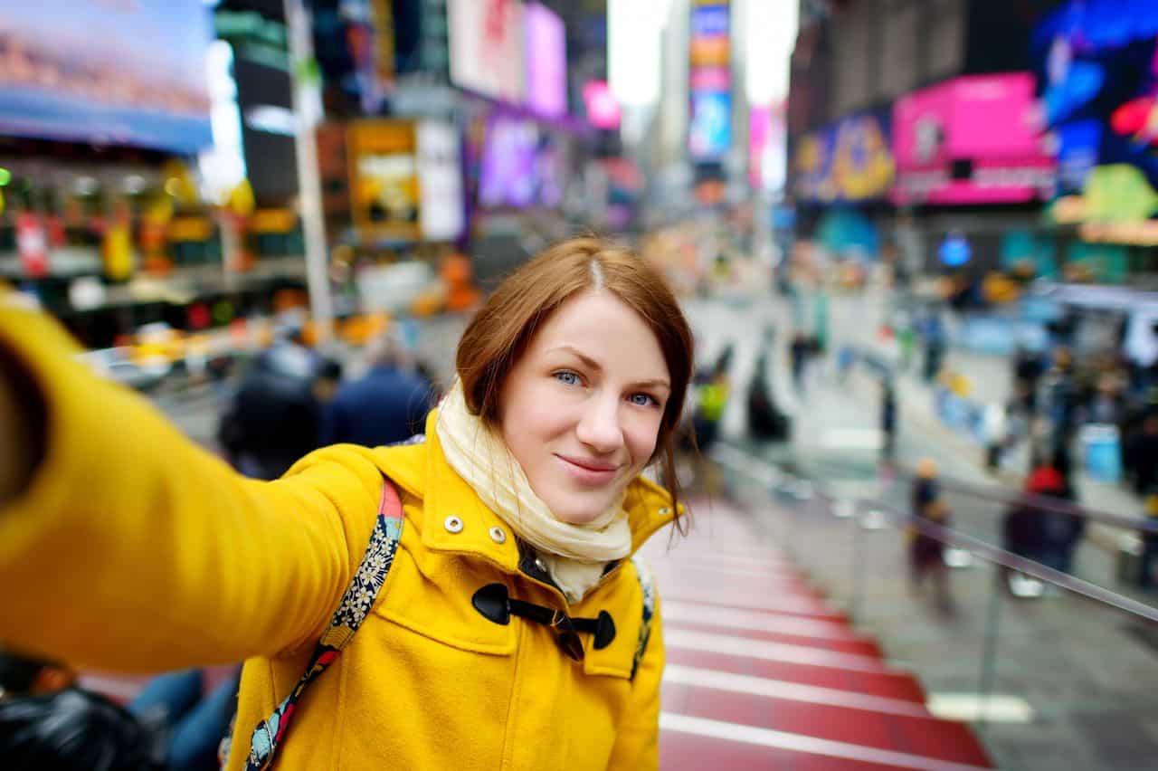 Woman taking selfie in Times Square