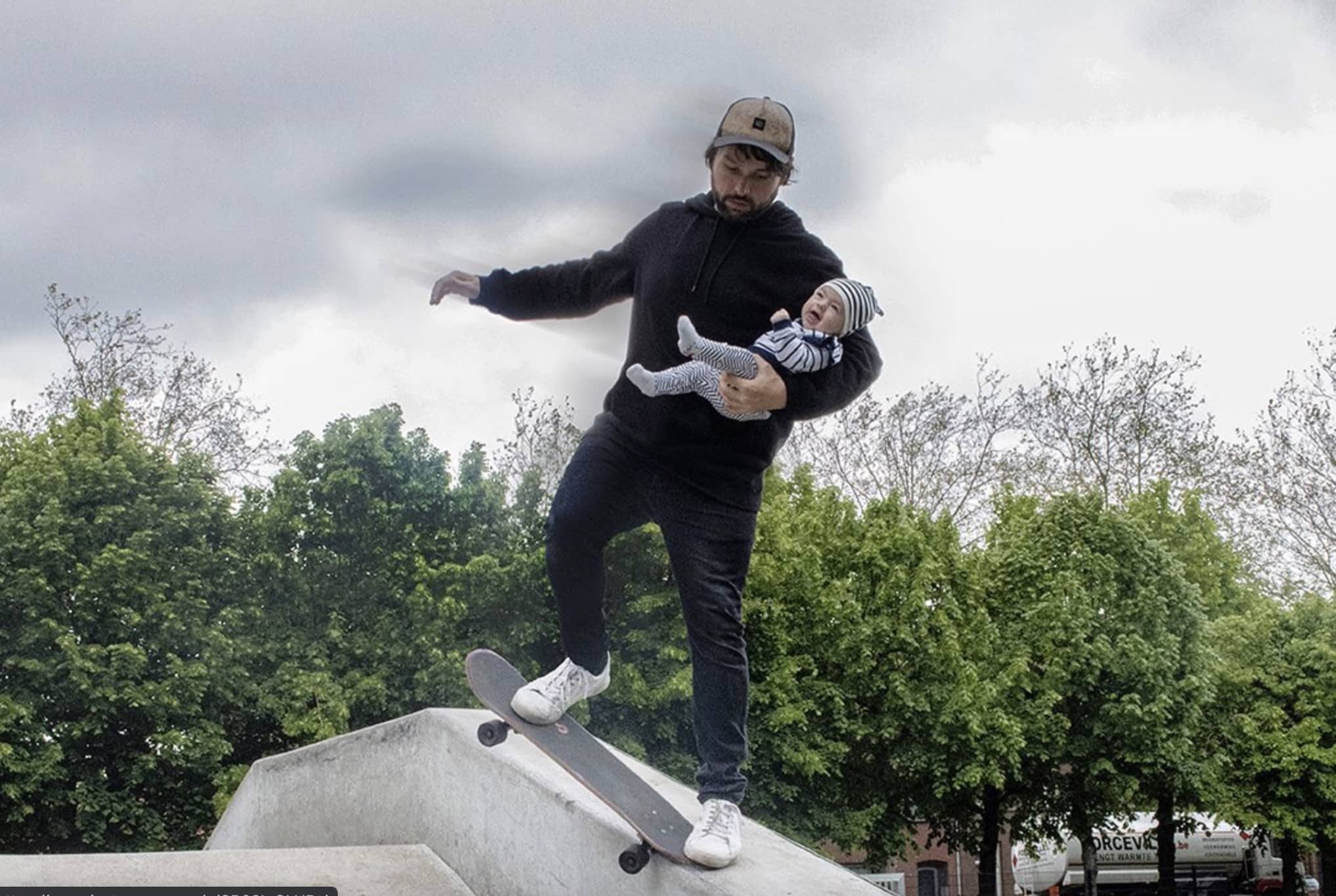 Dad skateboarding with his baby