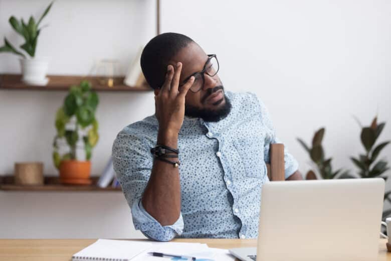 man is confused on his computer because google is trying to rid one of his his email accounts