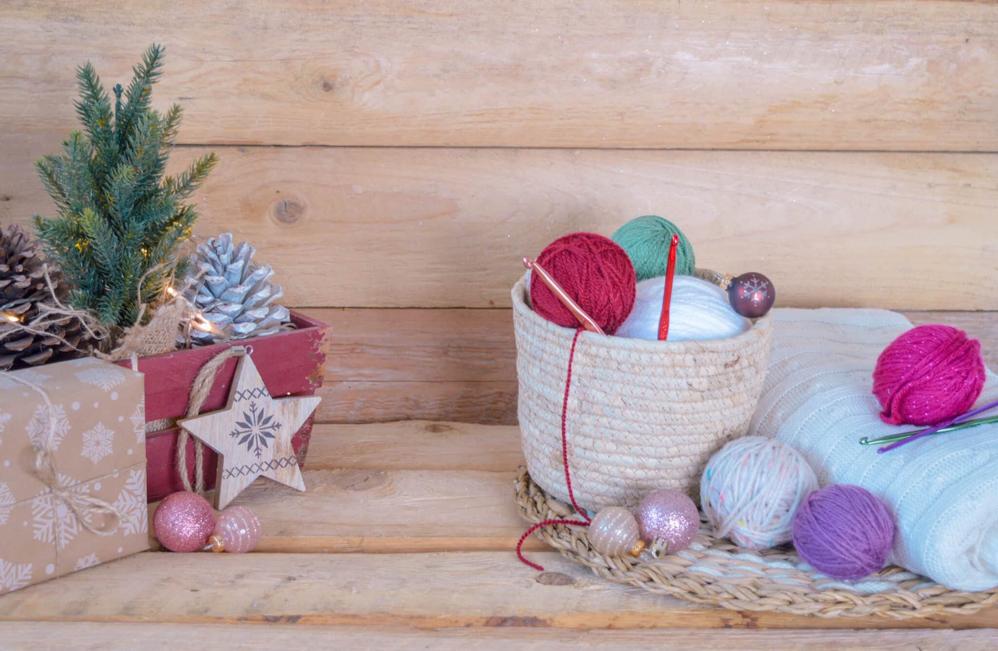 Christmas crochet patterns and balls of yarn ready to start Christmas crafts