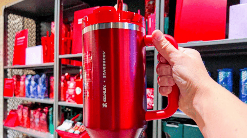 Hand holds Starbucks red Stanley cup