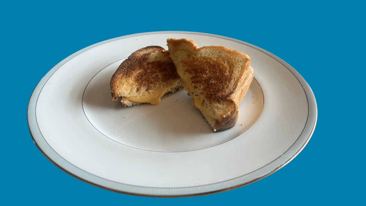 Grilled cheese sandwich cooked with ghee on a plate.