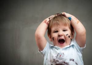 Small boy with stains all over his shirt and mouth