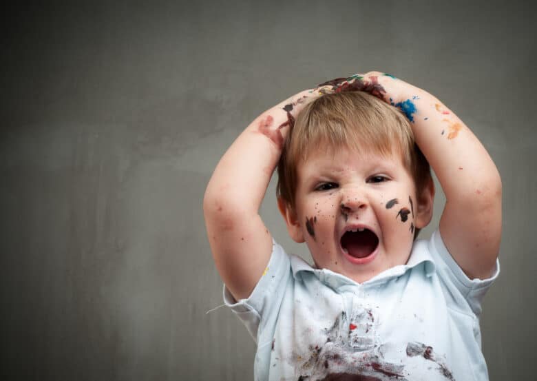 Small boy with stains all over his shirt and mouth