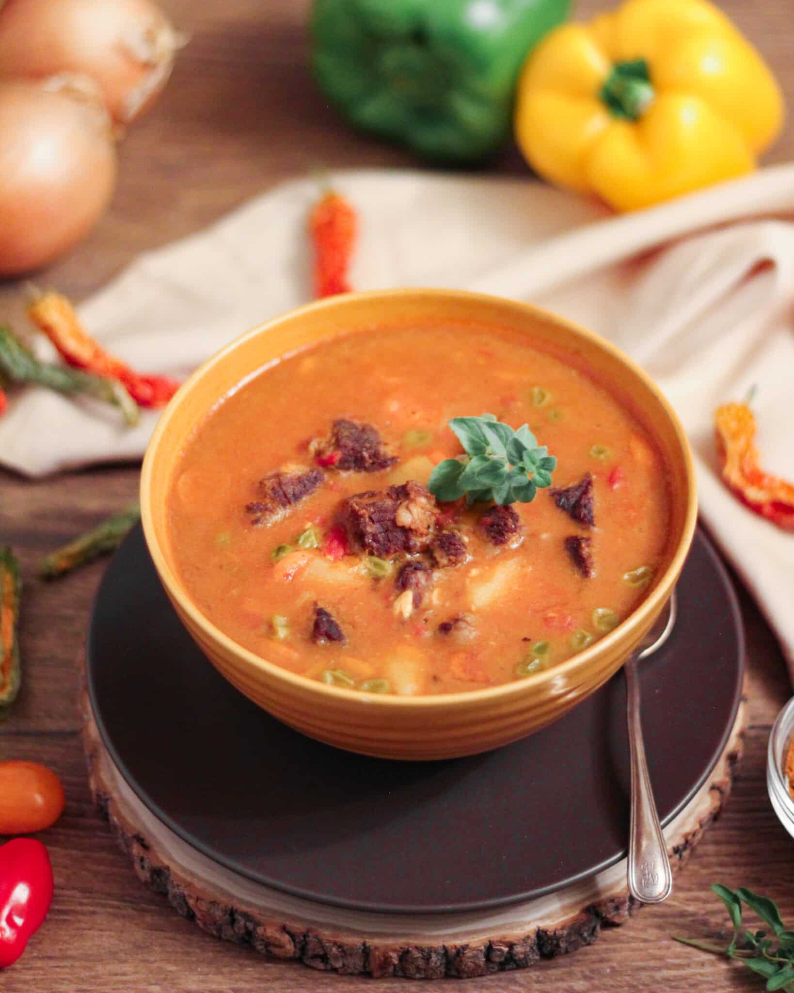 Beef goulash in a yellow bowl.