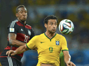 Brazil's forward Fred is challenged by Germany's defender Jérôme Boateng. Fred was heavily criticized for his performance and was booed by Brazilian fans when he was substituted.
