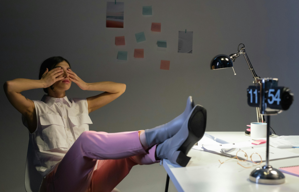 A worker exhausted at their desk at night