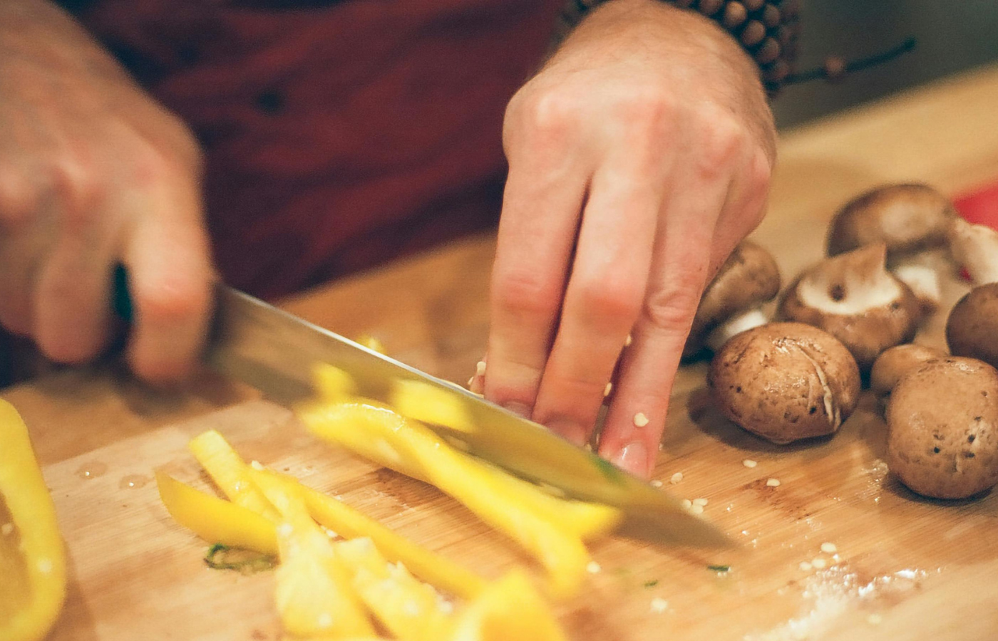 A person chopping vegetables with a sharp knife