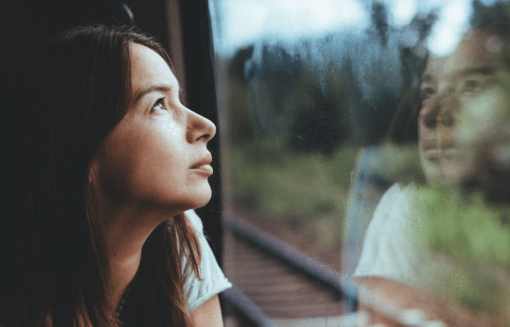 woman looking out the window
