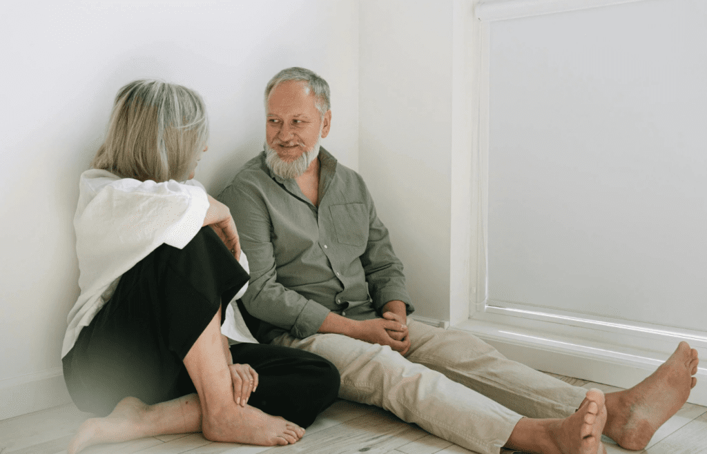 older man and woman talking