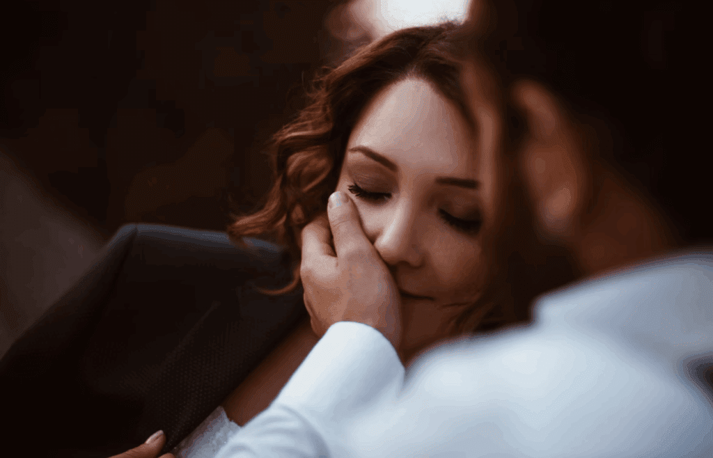 woman with hand on face