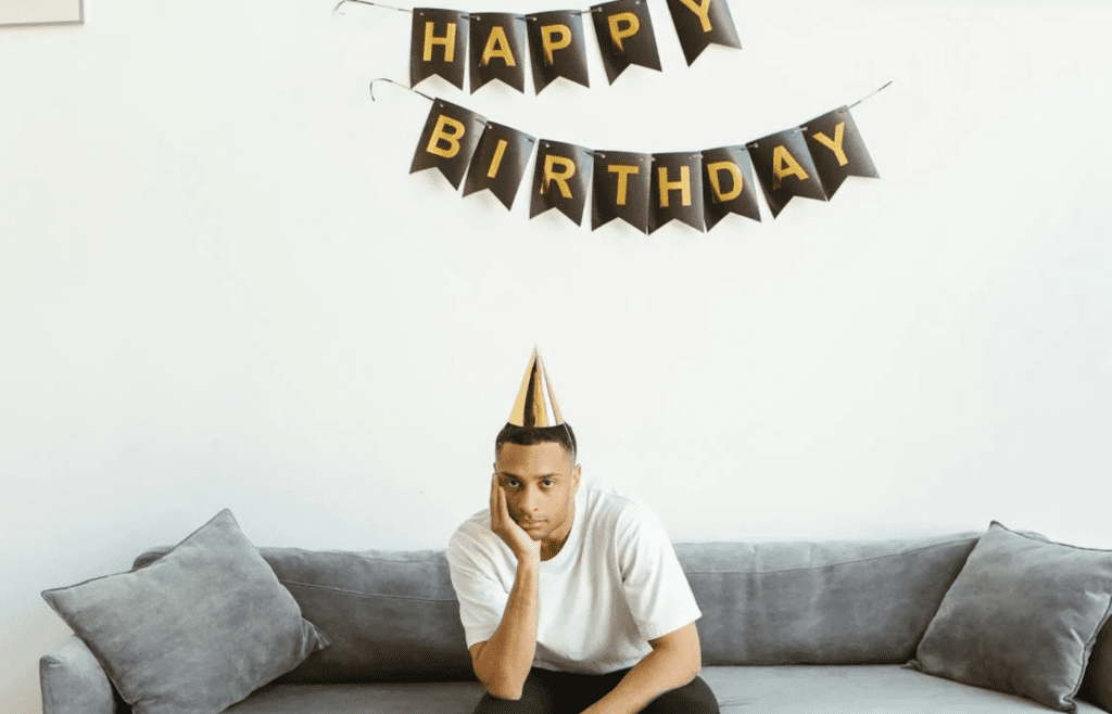 man with birthday banner