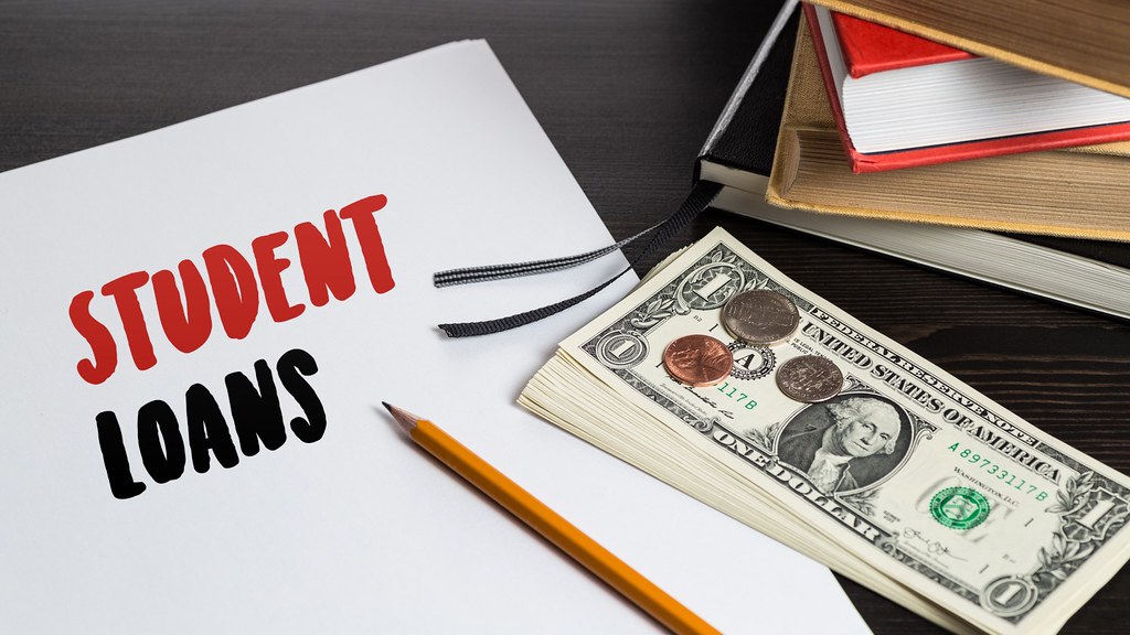 Student loan documents with cash on the side