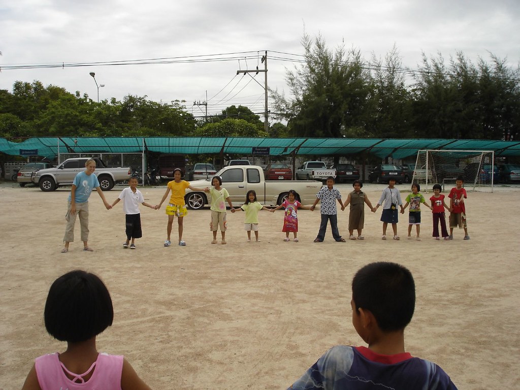 Kids lined up and holding hands to play Red Rover