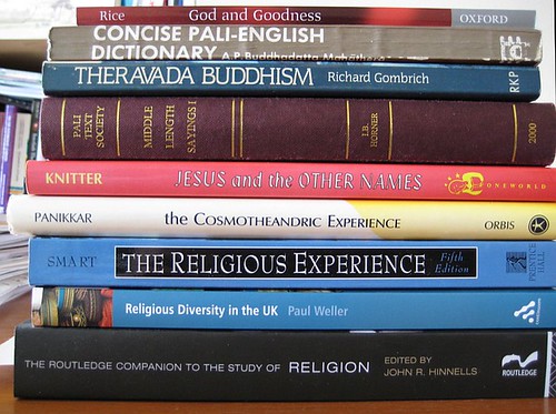 A small stack of books for religious studies