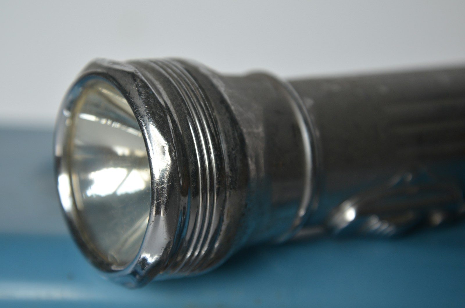 Close up of a vintage metal flashlight