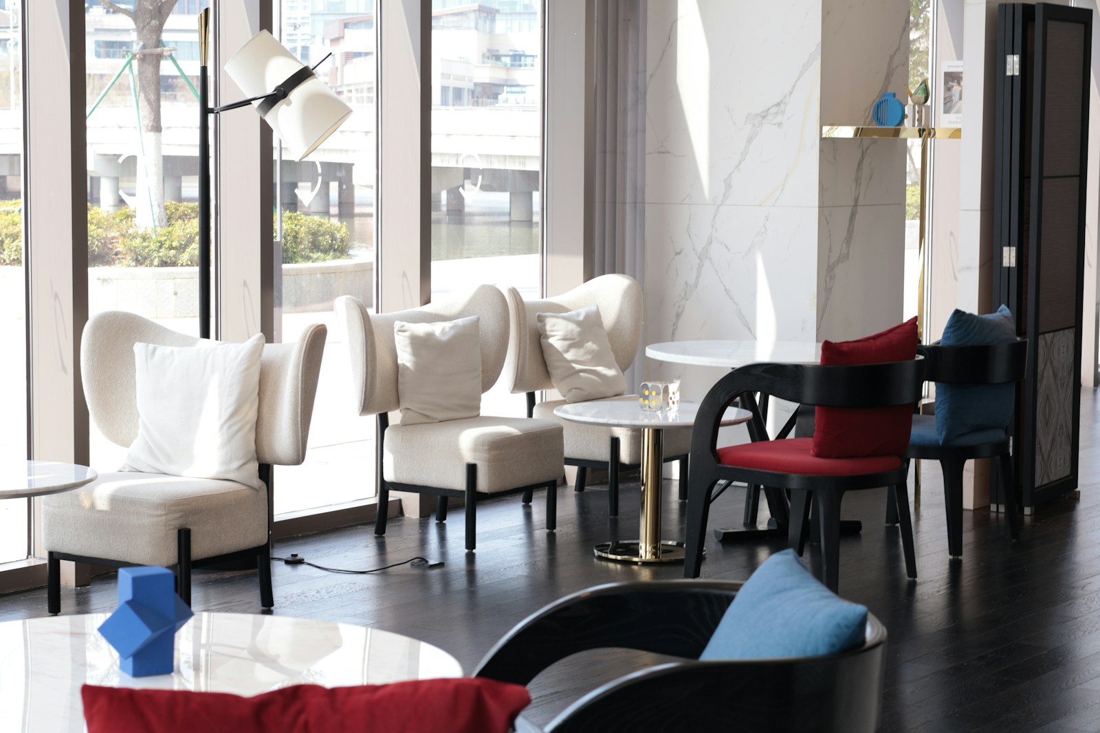 Modern lounge area with comfortable seating and tables.