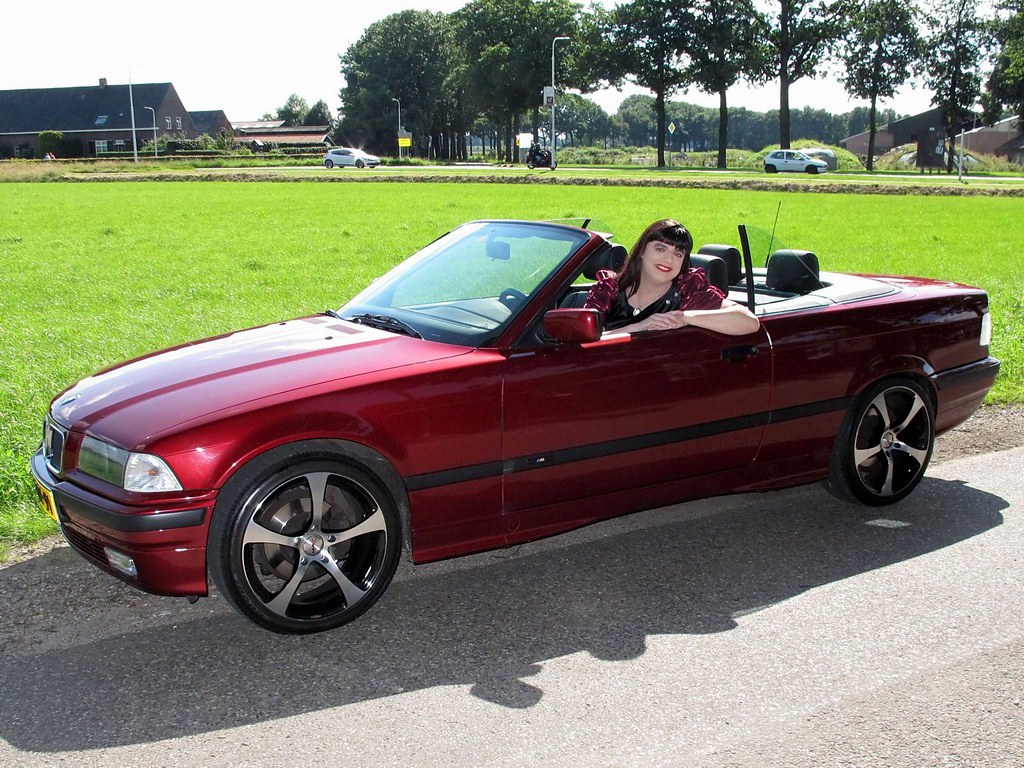 Woman in a red convertible sporty car