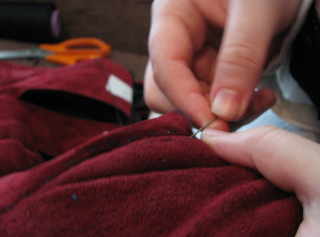 Close-up of hands sewing clothing